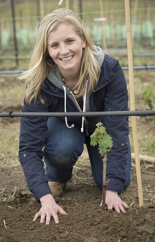 Winery Director Christine Clair planting a vine